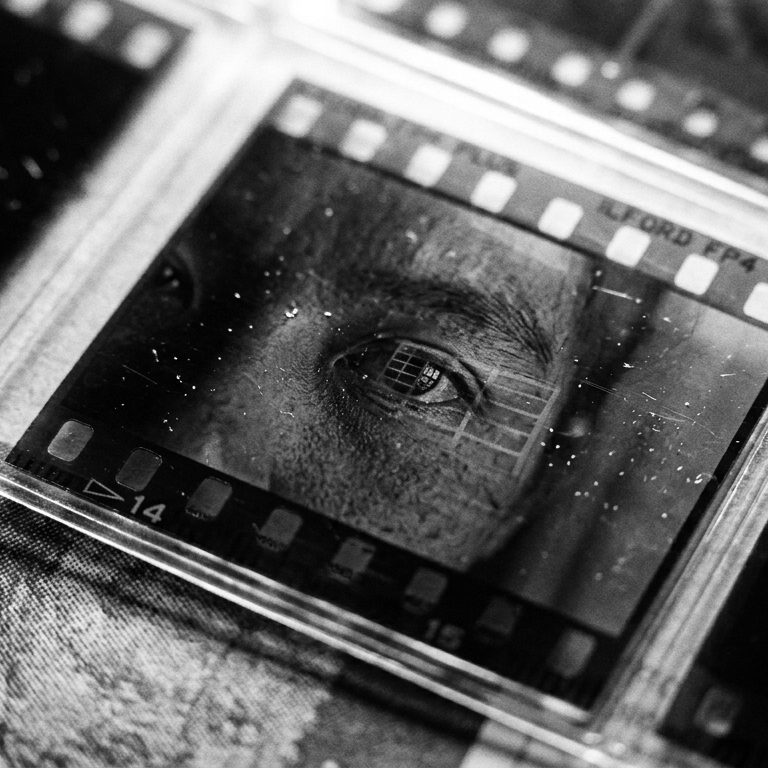A found black-and-white negative held in its film mount: an eye gazing out from the emulsion.